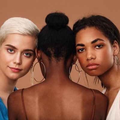 portrait-beautiful-women-with-touching-heads-against-brown-background_1048944-6290952